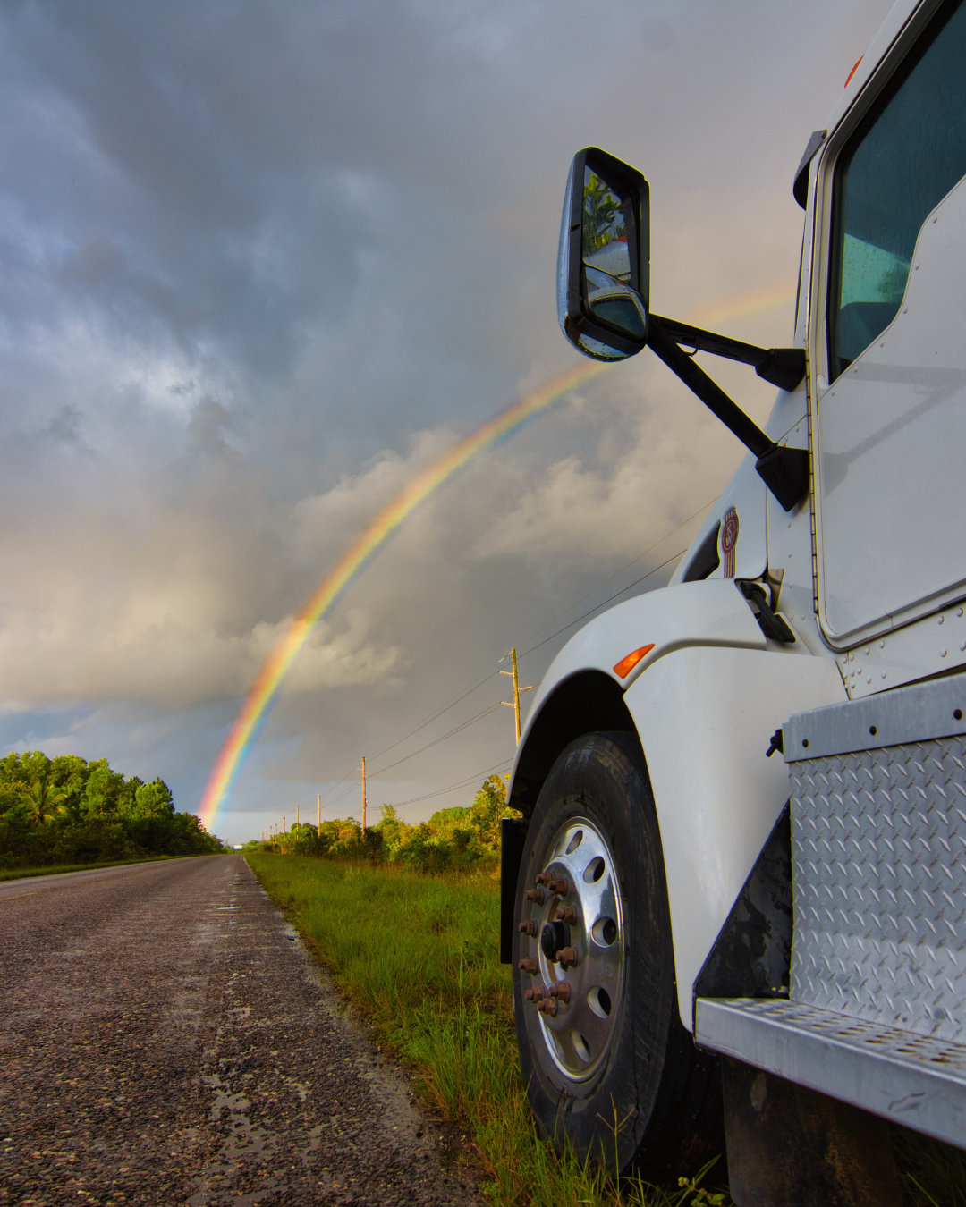 Rolls Right truck on the road under a rainbow